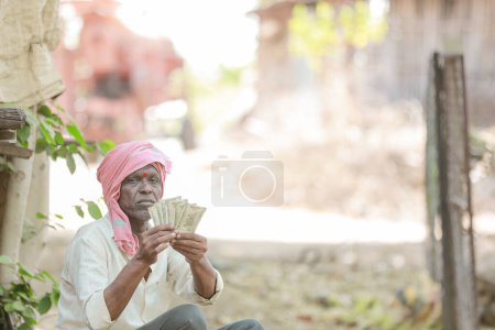 Photo for Rural Farmer Man Standing Field Showing Indian Currency Notes - Royalty Free Image