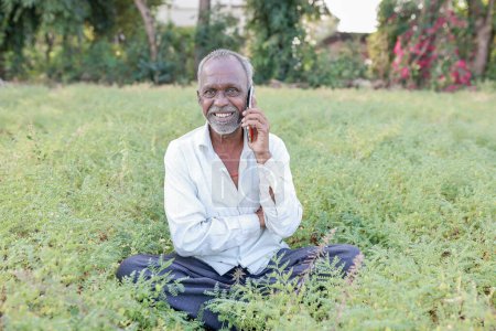 Indian chickpeas Farming , happy indian farmr holding mobile phone in hands, poor happy farmer