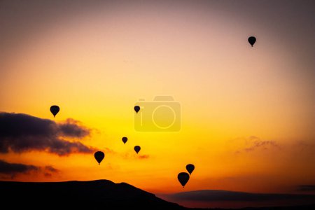 Photo for Hot air balloon at sunrise in Cappadocia, famous tourist activity - Royalty Free Image