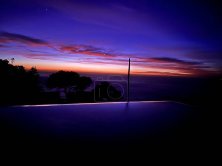 Photo for Modern city skyline at night and infinity pool. - Royalty Free Image