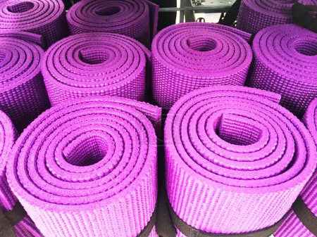 Photo for Yoga mats constricted, rolled-up on a shelf in the closet. - Royalty Free Image