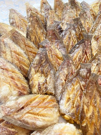 Pescado gourami de piel de serpiente frita con huevos en hojas de papel de aceite de arcos blancos.