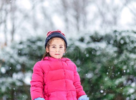 Photo for Snowy Serenity: Young Girl Standing in Gentle Winter Flurries - Royalty Free Image
