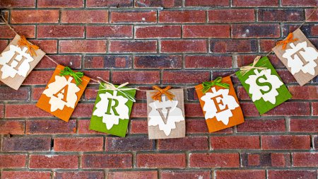 Photo for Fall Harvest sign hanging on brick wall - Royalty Free Image