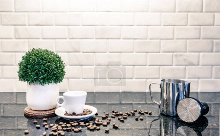 Photo for Espresso cup metal group head with dark roasted coffee beans with frothing pitcher and tamper - Royalty Free Image