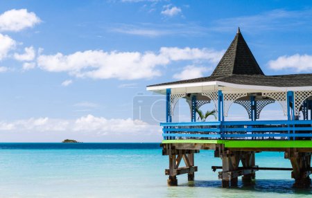 Photo for Ocean view pier with gazebo seating, tropical island beach vacation - Royalty Free Image
