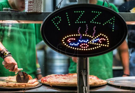 Photo for Neon Light Pizza Sign at Storefront of Authentic Italian Pizzeria - Royalty Free Image