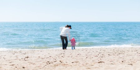 Photo for Young Mother and Toddler at Ocean's Edge - Royalty Free Image