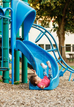 Toddler Falling Down Backwards on Playground Slide