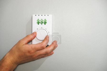 Hand Adjusting Thermostat to Save on Heating and cooling Costs