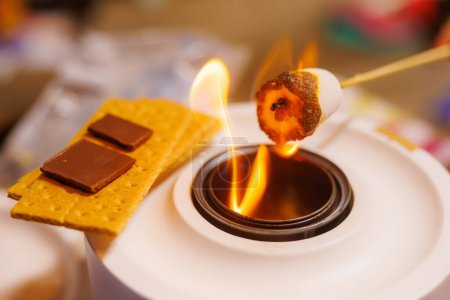 Photo for Making S'mores Over a Portable Campfire - Royalty Free Image