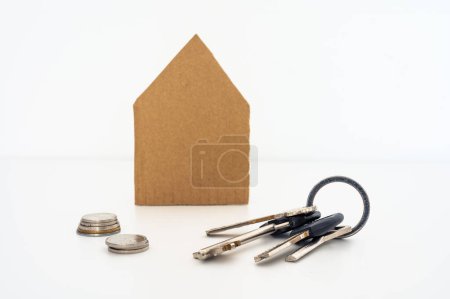 Photo for Cardboard house with bunch of keys and coins in front - Royalty Free Image