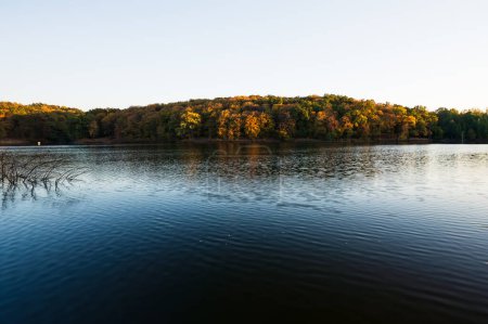 Photo for Beautiful scenic panoramic autumn view on bank of lake with trees. Golden hour. Card, wallpaper - Royalty Free Image