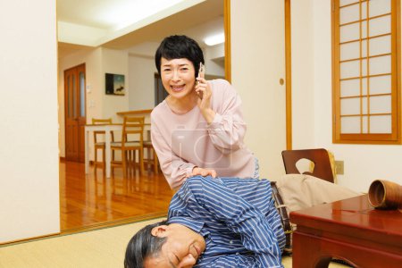 Photo for Senior asian man fainted and woman calling emergency - Royalty Free Image
