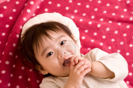 Photo for Close up portrait of asian little girl lying on bed - Royalty Free Image