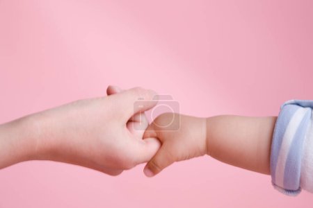 Photo for Mother and little daughter holding hands, closeup - Royalty Free Image