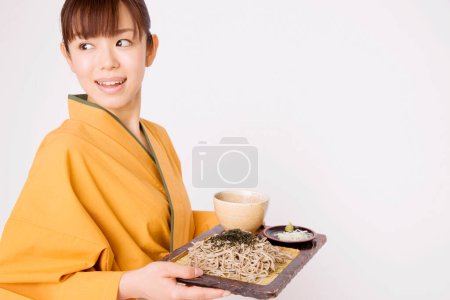 Photo for Asian woman waitress in traditional kimono serving food - Royalty Free Image
