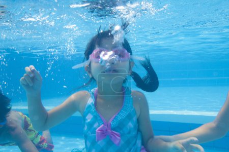 Photo for Portrait of happy asian girl with underwater goggles in swimming pool - Royalty Free Image