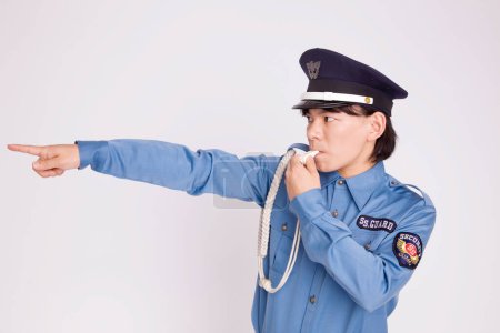 Photo for Studio shot of asian police officer with whistle - Royalty Free Image