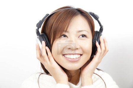 Beauty japanese woman in modern headphones on white background