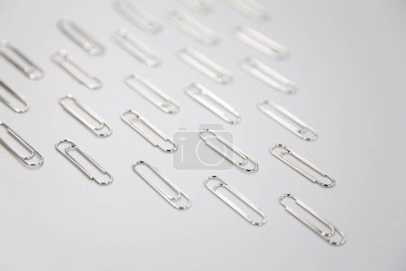 Photo for Silver paper clips on white background - Royalty Free Image