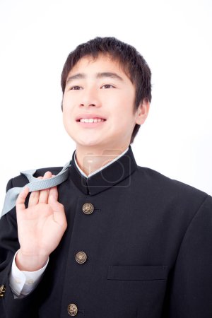 Portrait of Japanese school boy posing on white studio background 