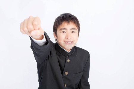 Portrait of Japanese school boy gesturing on white studio background 