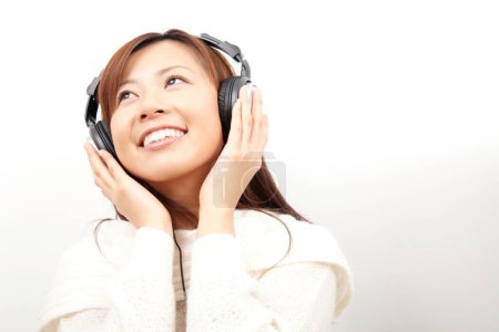 Beauty japanese woman in modern headphones on white background