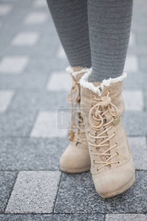 Photo for Female legs in boots on a street - Royalty Free Image