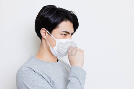 Photo for Asian man in protective mask on wall background - Royalty Free Image