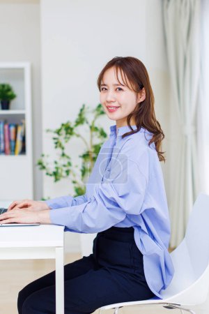 Junge Japanerin arbeitet zu Hause. Ferngesteuertes Arbeitskonzept