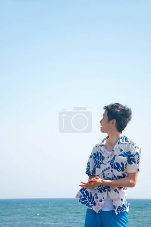 Photo for Young asian man on the beach - Royalty Free Image