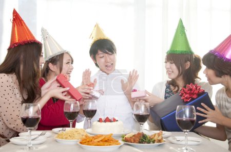 Photo for Asian friends celebrating birthday, having party at home - Royalty Free Image