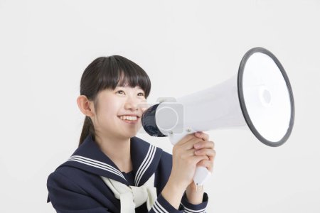 Foto de Joven asiático colegiala con megáfono en blanco fondo - Imagen libre de derechos