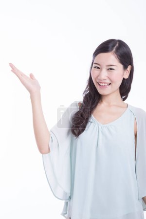 Photo for Studio portrait of beautiful Asian woman pointing - Royalty Free Image