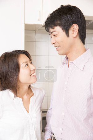 Photo for Happy young couple in kitchen - Royalty Free Image