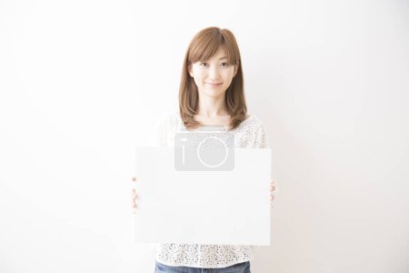 Photo for Portrait of asian woman with white board, studio shot - Royalty Free Image