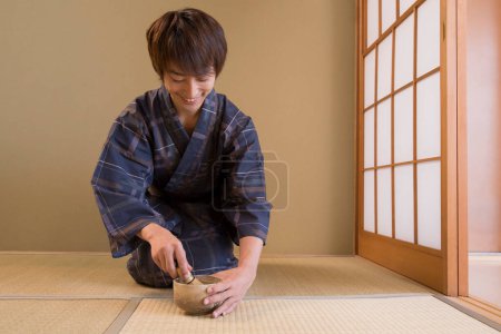 portrait of handsome japanese young man in traditional yukata in ethnic hot spring hotel
