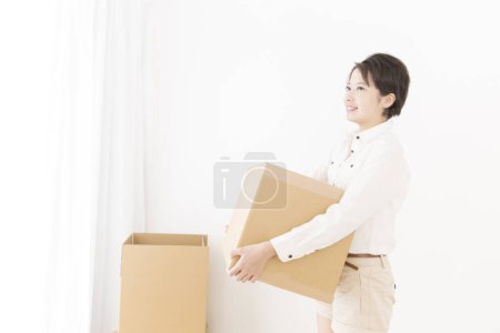 Photo for Beautiful asian woman with cardboard boxes at home - Royalty Free Image