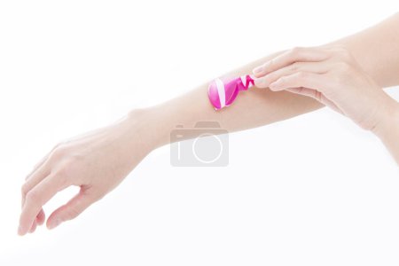 Photo for Close up woman shaving her arm - Royalty Free Image