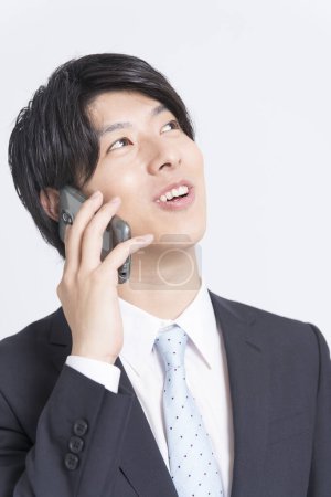 Photo for Portrait of young asian businessman talking on smartphone - Royalty Free Image