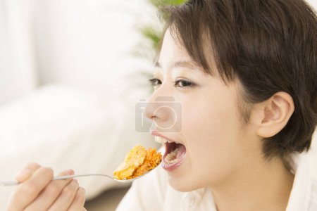 Photo for Beautiful  Japanese woman having a lunch at home - Royalty Free Image