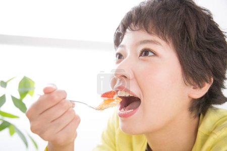 Photo for Asian woman eating cake - Royalty Free Image