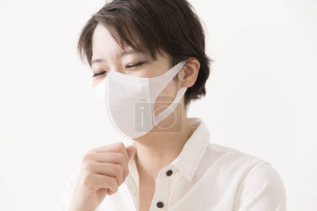 Photo for Sick Asian woman wearing protective mask - Royalty Free Image