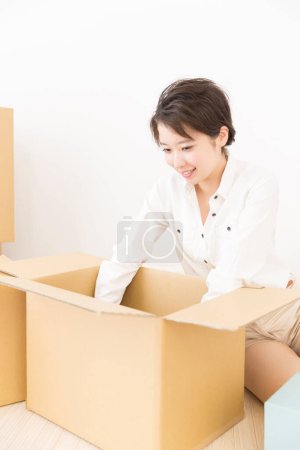 Photo for Beautiful asian woman with cardboard boxes at home - Royalty Free Image