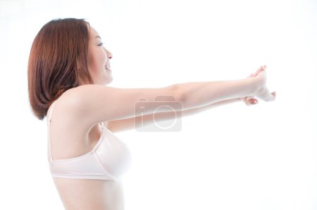 Photo for Beautiful sexy Japanese woman in underwear doing morning exercises on bed - Royalty Free Image