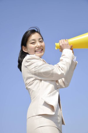 Photo for Asian woman with loud speaker outdoors - Royalty Free Image