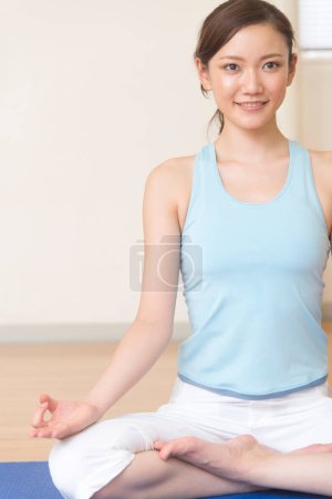 Photo for Young woman doing yoga at gym - Royalty Free Image