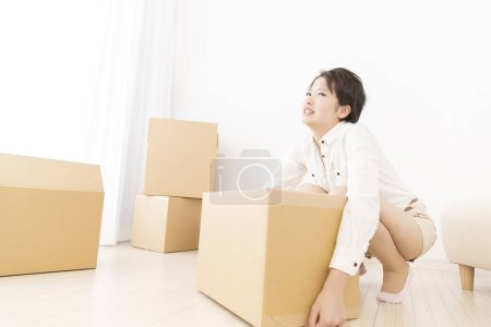 Photo for Young asian woman moving into new apartment - Royalty Free Image