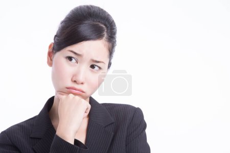 Photo for Young asian business woman in suit with sad face - Royalty Free Image